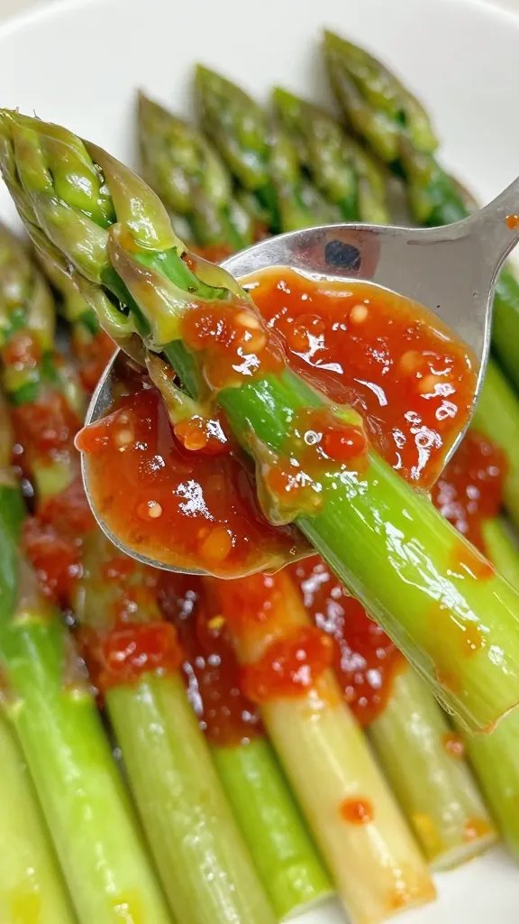Red Fork Asparagus Sauce: Bold Weeknight Win 5 Closeup of spoon lifting red-tinted sauce over green asparagus tips