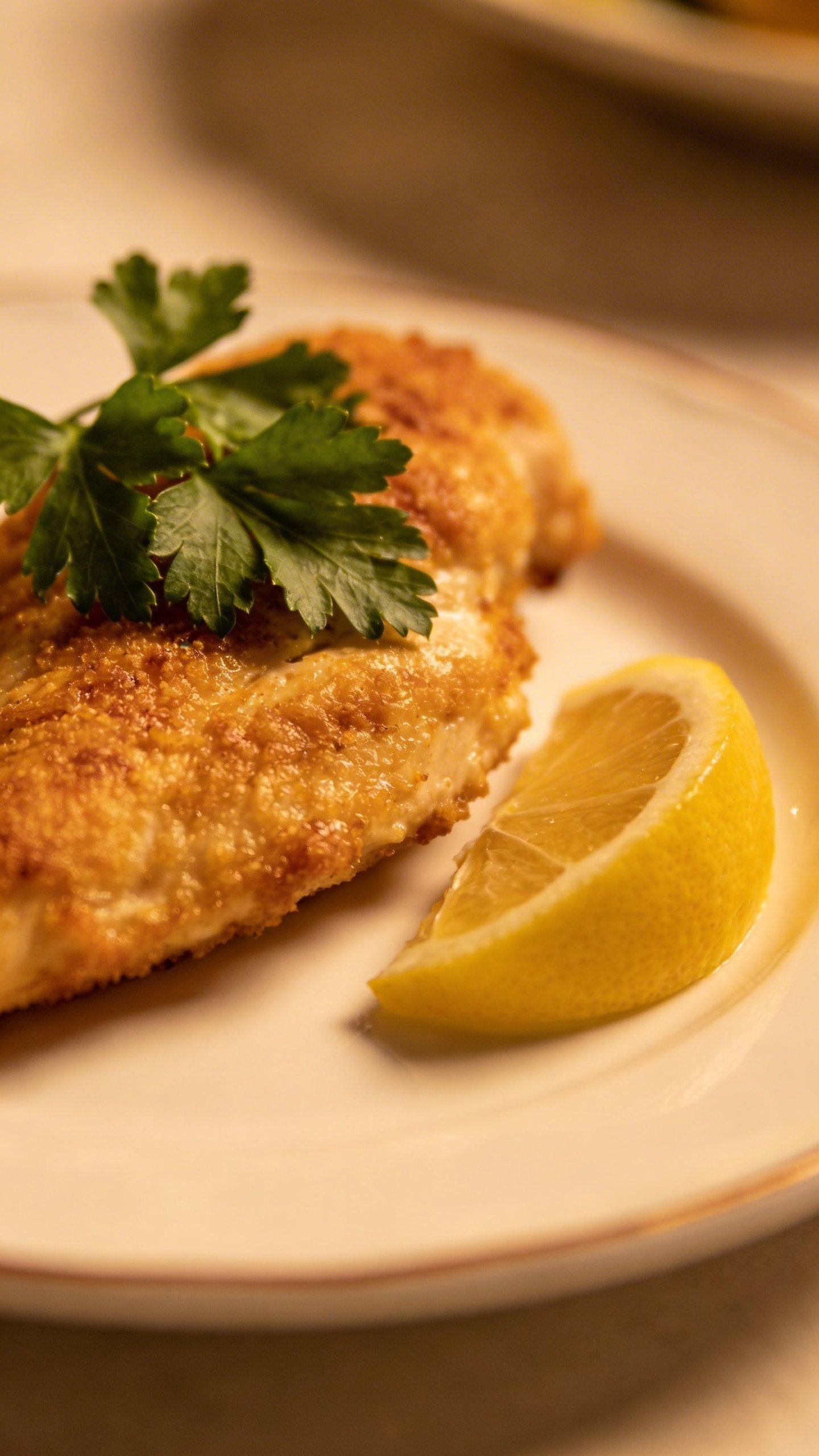 Lemon Garlic Chicken Skillet Triumph in 20 Minutes 5 single plated chicken breast with parsley garnish and lemon wedge closeup