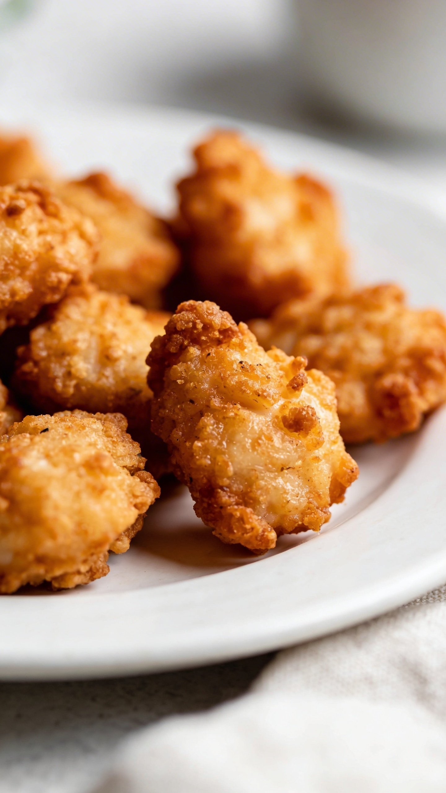 Crispy Perfection: Air Fryer Chicken Bites Tonight 3 Closeup of crispy air-fried chicken bites on a white plate