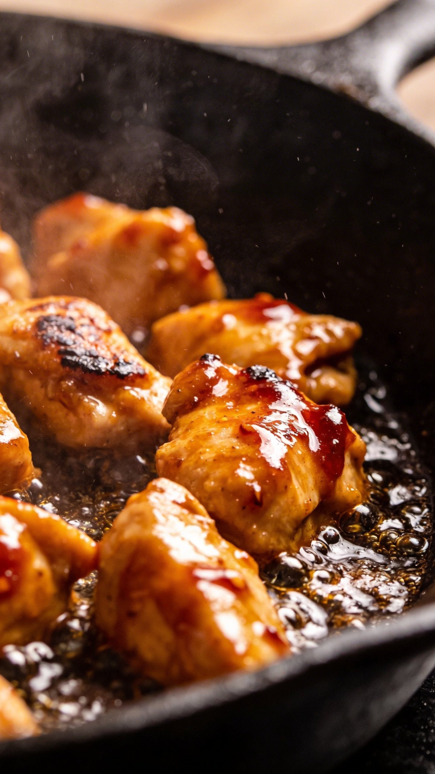 Sweet Chili Chicken: Weeknight Dinner Knockout 4 closeup of sizzling chicken chunks in sweet chili glaze skillet