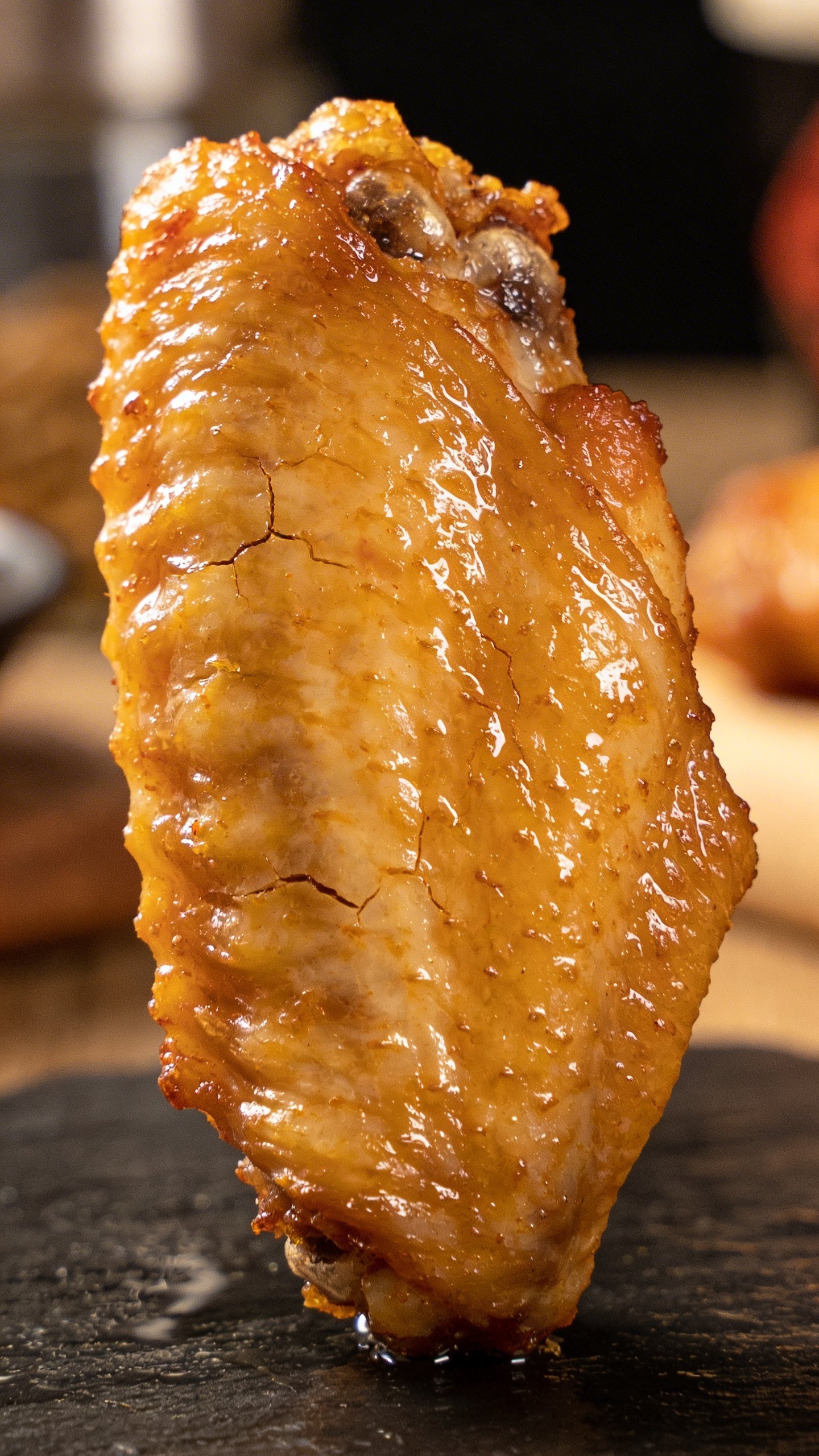Korean Fried Chicken Recipe: Crispy, Glossy, Addictive Wings 4 Closeup of crispy skin on single chicken wing under warm kitchen lighting
